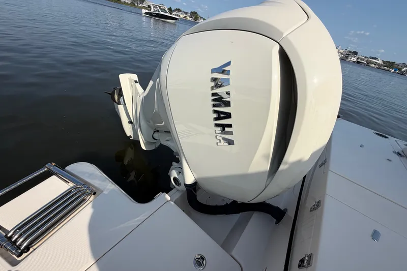 Slide: The Image of 2025 Grady-White Freedom 235 boat with Yamaha outboard motor on calm water. - 36