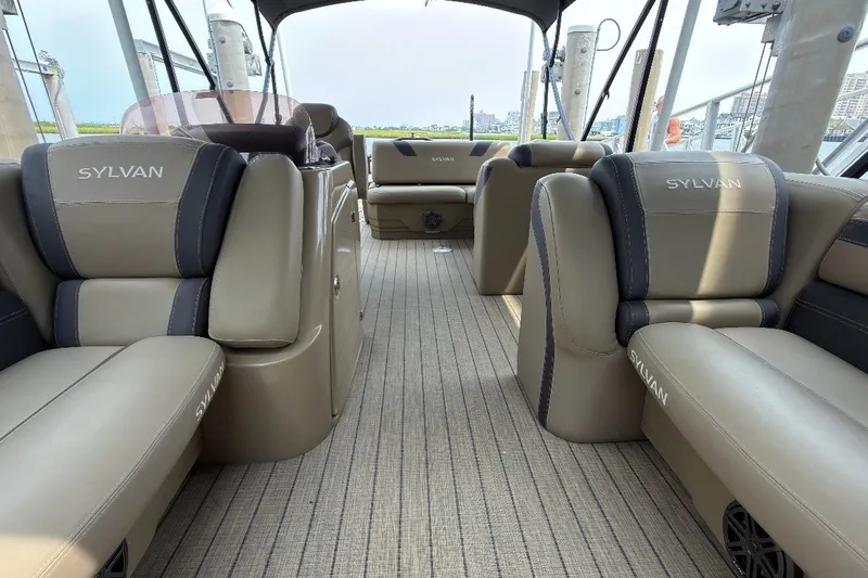 Slide: The Image of The image shows the interior of a 2023 Sylvan L5 DLZ Bar boat with luxurious seating. - 6