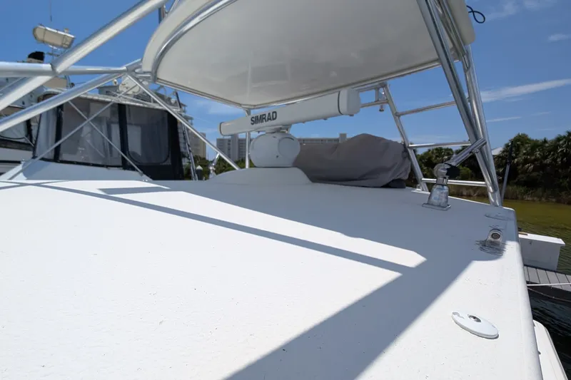 Slide: The Image of 2005 Rampage 38 Express boat deck with Simrad equipment under clear blue sky. - 10
