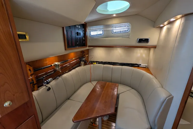 Slide: The Image of Luxurious interior of 2005 Rampage 38 Express yacht with plush seating and fishing rods. - 25