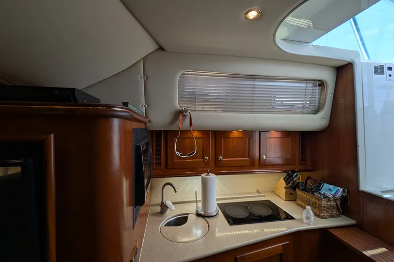 Slide: The Image of Interior of 2005 Rampage 38 Express yacht kitchen with wooden cabinets and modern appliances. - 29