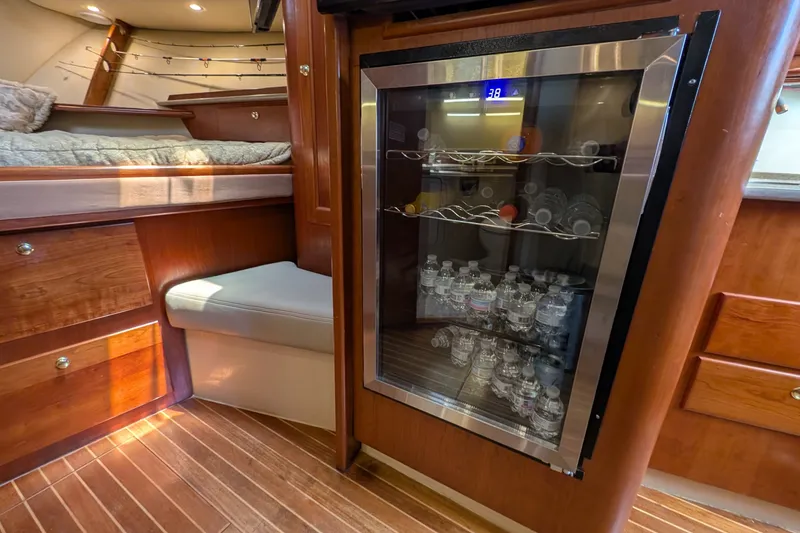 Slide: The Image of Interior of 2005 Rampage 38 Express yacht with mini fridge and wooden cabinetry. - 24