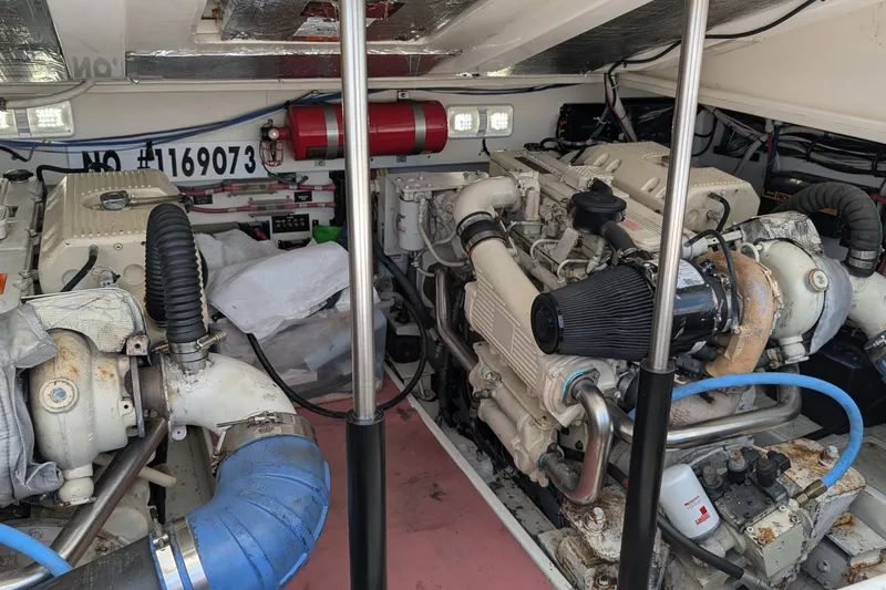 Slide: The Image of Engine room of a 2005 Rampage 38 Express boat, showcasing dual engines and equipment. - 30