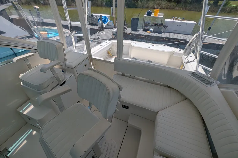Slide: The Image of Interior of 2005 Rampage 38 Express boat with white seating and helm chairs. - 20