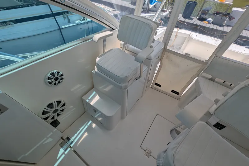 Slide: The Image of 2005 Rampage 38 Express boat interior with white seating and speakers. - 21