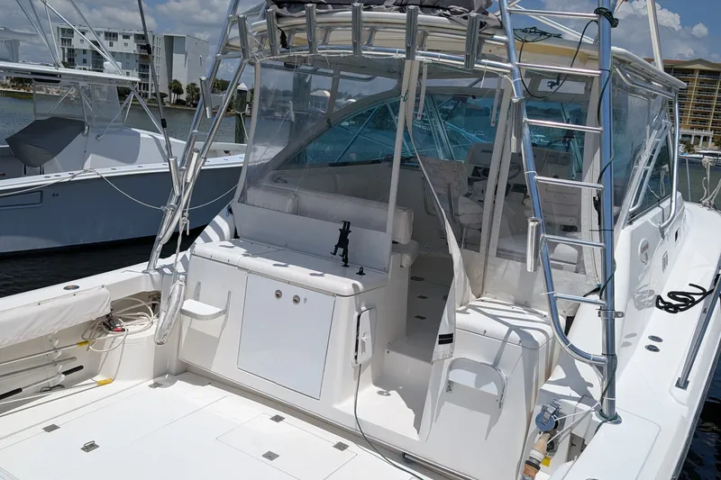 Slide: The Image of 2005 Rampage 38 Express boat with spacious deck and modern amenities docked at marina. - 4