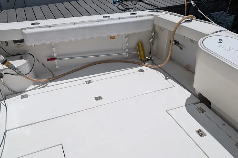 Slide: The Image of 2005 Rampage 38 Express boat deck with storage compartments and cleaning equipment. - 19