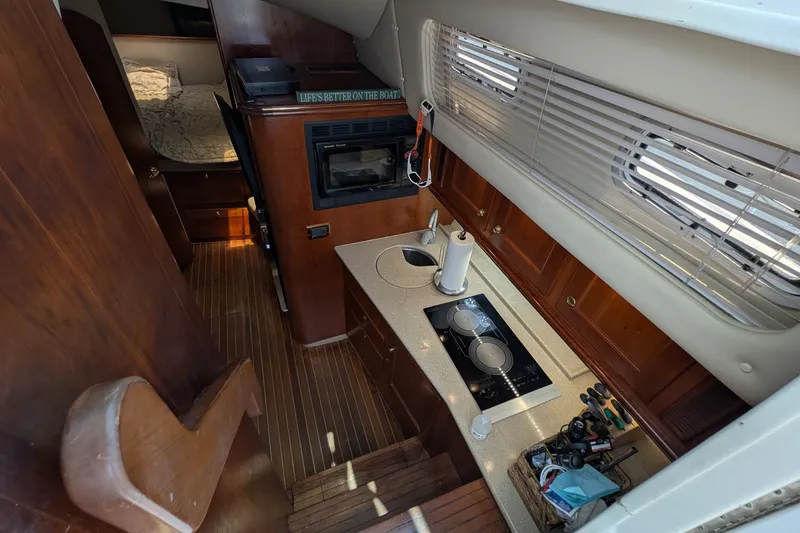 Slide: The Image of Interior of 2005 Rampage 38 Express yacht with kitchen and sleeping area. - 22