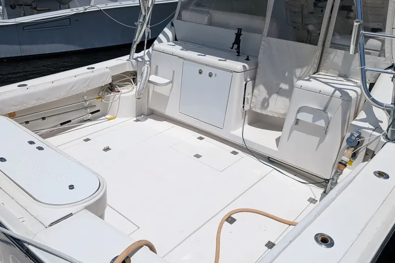 Slide: The Image of 2005 Rampage 38 Express boat deck with storage compartments and fishing rod holders. - 13