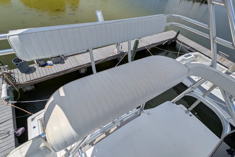 Slide: The Image of Upper deck seating on a 2005 Rampage 38 Express boat at a dock. - 8
