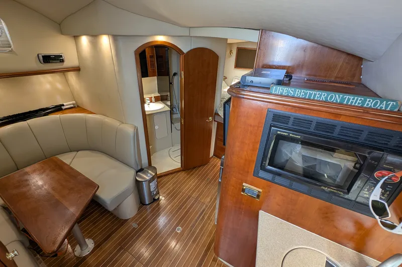 Slide: The Image of Interior of a 2005 Rampage 38 Express boat with cozy seating and kitchenette. - 23