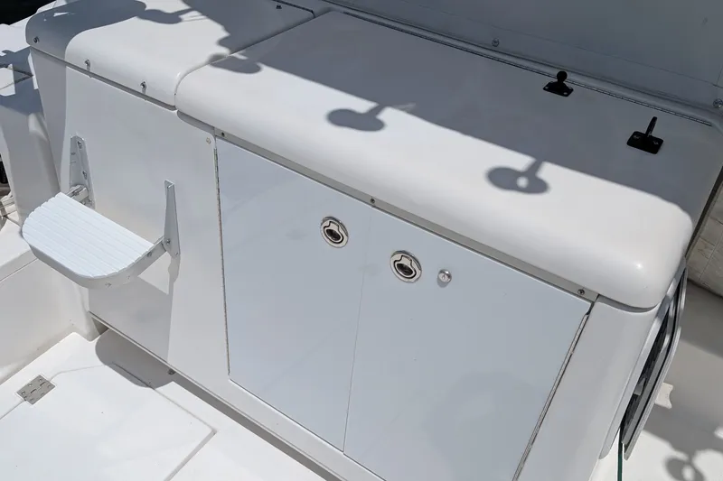 Slide: The Image of 2005 Rampage 38 Express boat deck with storage compartments and step. - 18