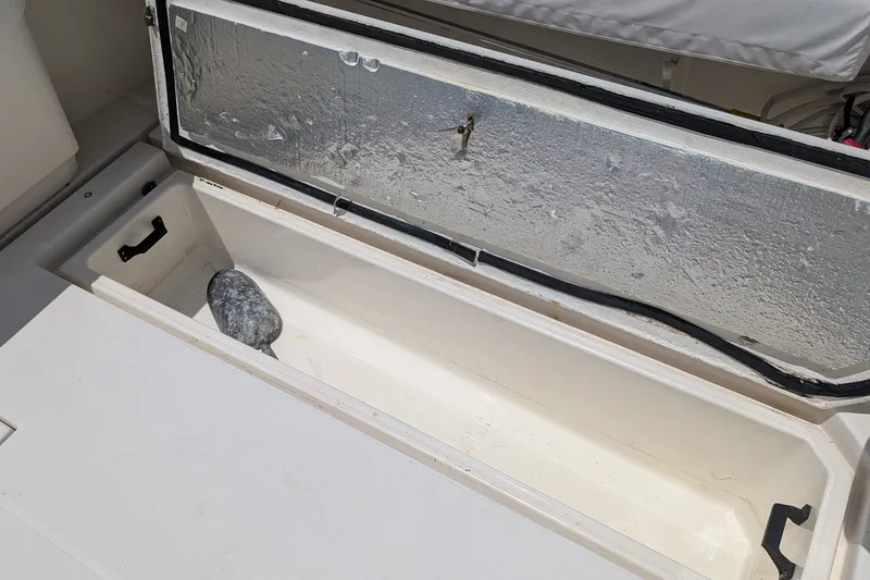 Slide: The Image of Open storage compartment on 2005 Rampage 38 Express boat, showing interior space. - 17