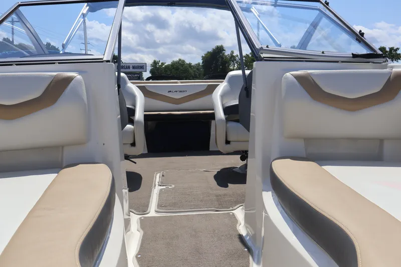 Slide: The Image of Interior view of a 2012 Larson LX 2150 boat with beige and white seating. - 37