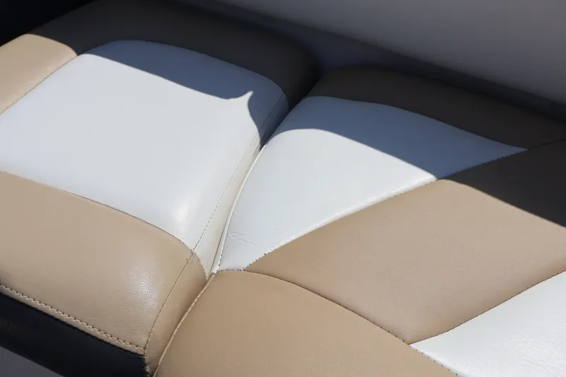 Slide: The Image of Close-up of Larson LX 2150 2012 boat seat with beige and white upholstery. - 22
