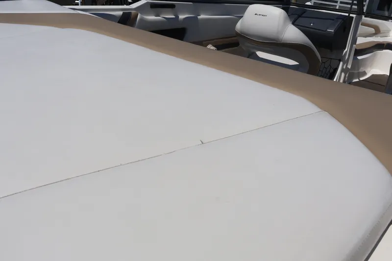 Slide: The Image of 2012 Larson LX 2150 boat interior with beige and white upholstery. - 16