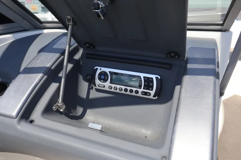 Slide: The Image of 2012 Larson LX 2150 boat dashboard with stereo system and protective cover open. - 41