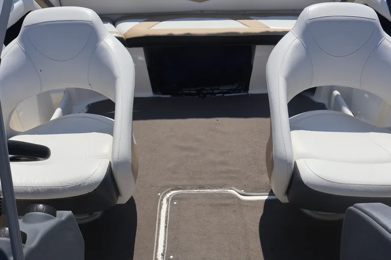 Slide: The Image of Interior of a 2012 Larson LX 2150 boat with white seating and carpeted floor. - 25