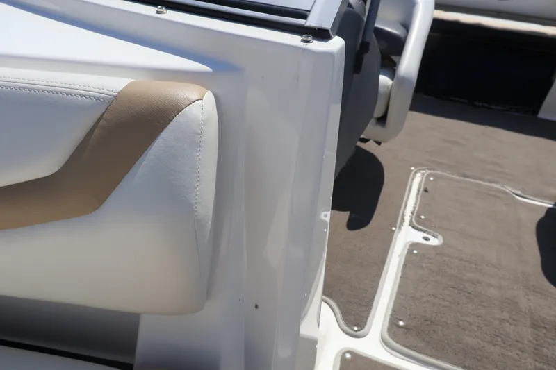 Slide: The Image of Interior view of a 2012 Larson LX 2150 boat, featuring white and tan seating. - 39