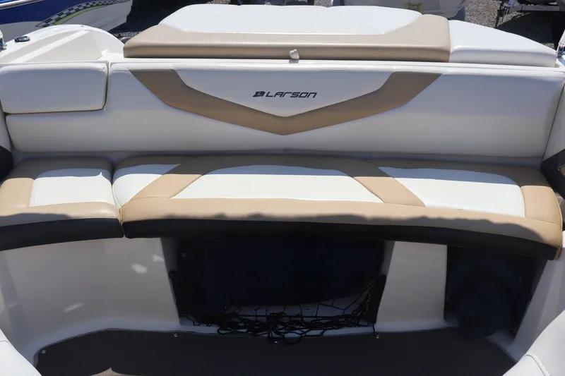 Slide: The Image of 2012 Larson LX 2150 boat interior seating with beige and white upholstery. - 19