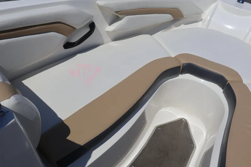 Slide: The Image of Interior seating of a 2012 Larson LX 2150 boat with beige and white upholstery. - 35