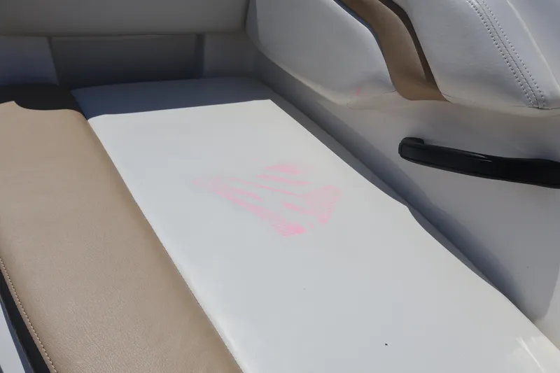 Slide: The Image of Interior seating of a 2012 Larson LX 2150 boat, featuring beige and white upholstery. - 36