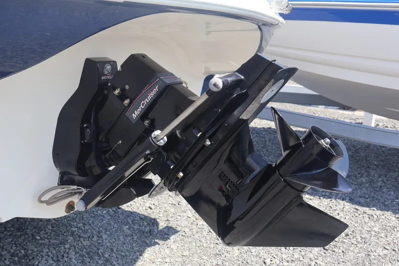Slide: The Image of 2012 Larson LX 2150 boat with MerCruiser outboard motor, displayed on gravel. - 13