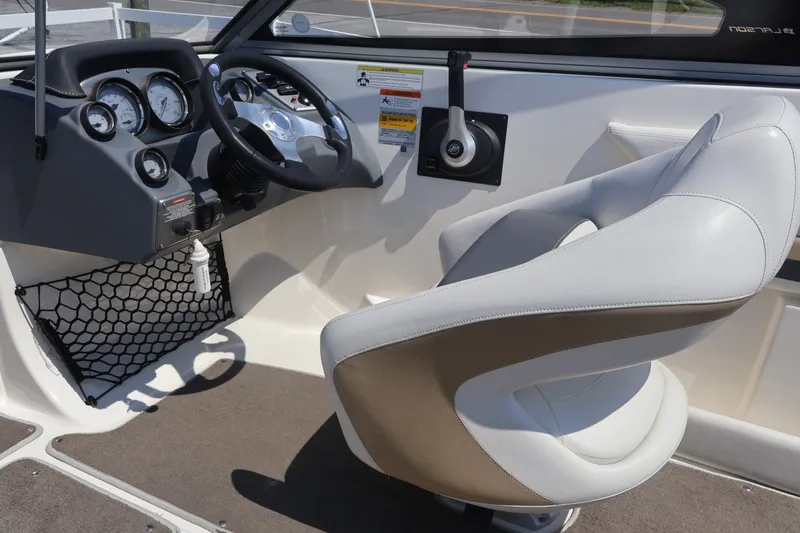Slide: The Image of Interior of a 2012 Larson LX 2150 boat showing steering wheel and controls. - 32