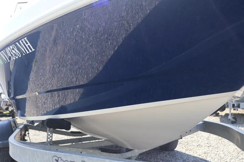 Slide: The Image of 2012 Larson LX 2150 boat on trailer, close-up view of hull. - 3