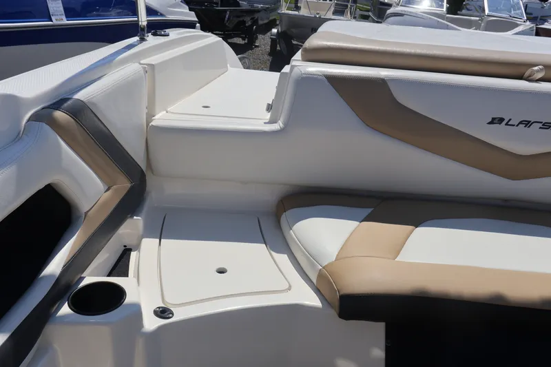 Slide: The Image of Interior of a 2012 Larson LX 2150 boat with beige and white seating. - 17