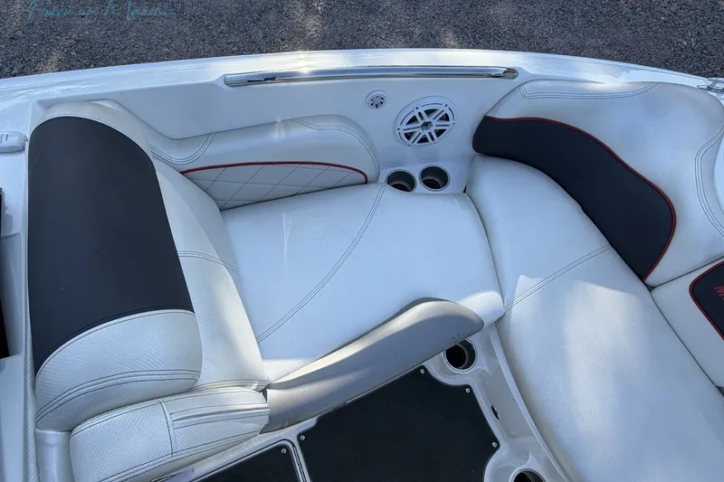 Slide: The Image of 2011 MasterCraft X-35 boat interior with white and black seating, cup holders, and speaker. - 26