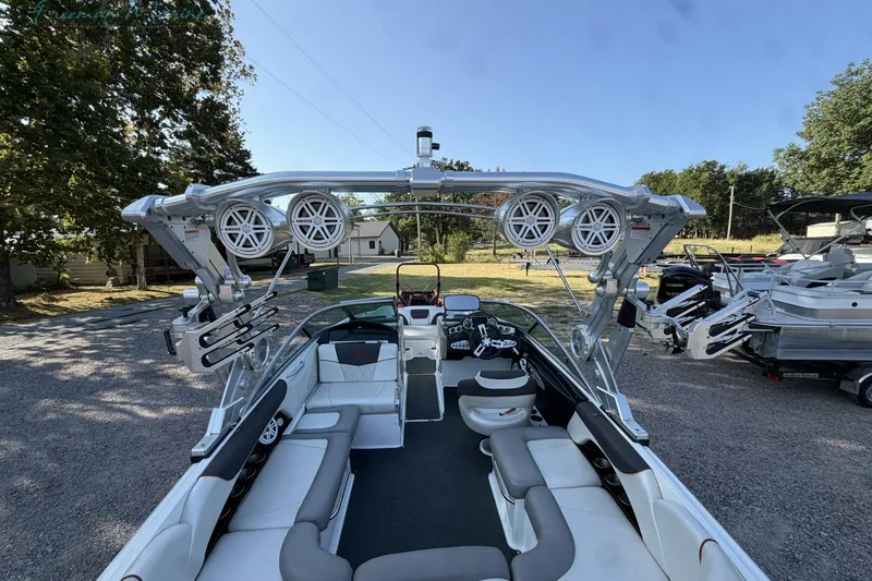 Slide: The Image of 2011 MasterCraft X-35 boat interior with speakers and seating, parked outdoors. - 15