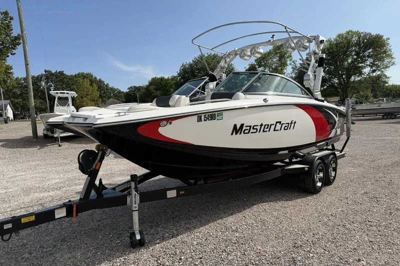 Slide: The Image of 2011 MasterCraft X-35 boat on trailer in outdoor setting. - 9