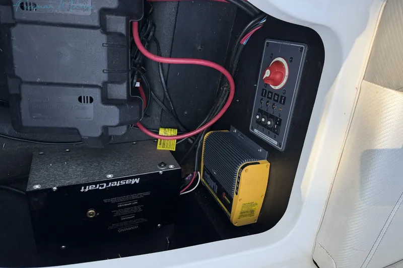 Slide: The Image of 2011 MasterCraft X-35 boat electrical panel with battery and wiring components. - 38