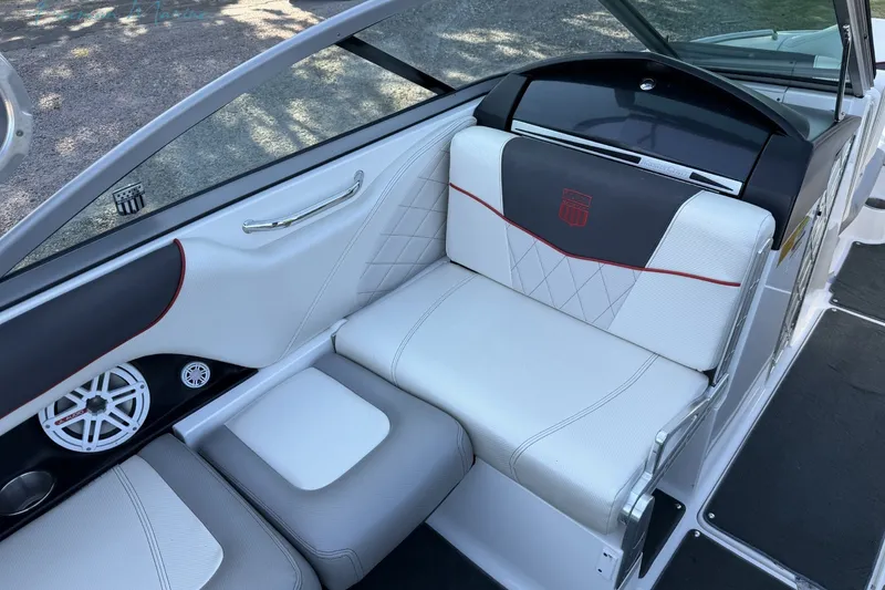 Slide: The Image of Interior of 2011 MasterCraft X-35 boat with white and gray seating, speaker, and cup holder. - 23
