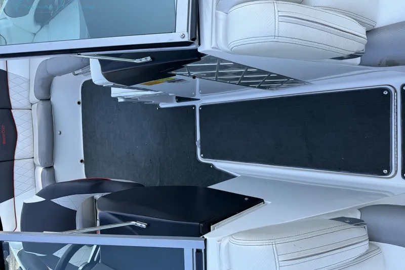 Slide: The Image of 2011 MasterCraft X-35 boat interior with white seating and black flooring. - 30