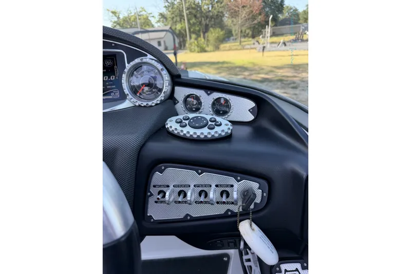 Slide: The Image of Dashboard of a 2011 MasterCraft X-35 boat with gauges and controls. - 46