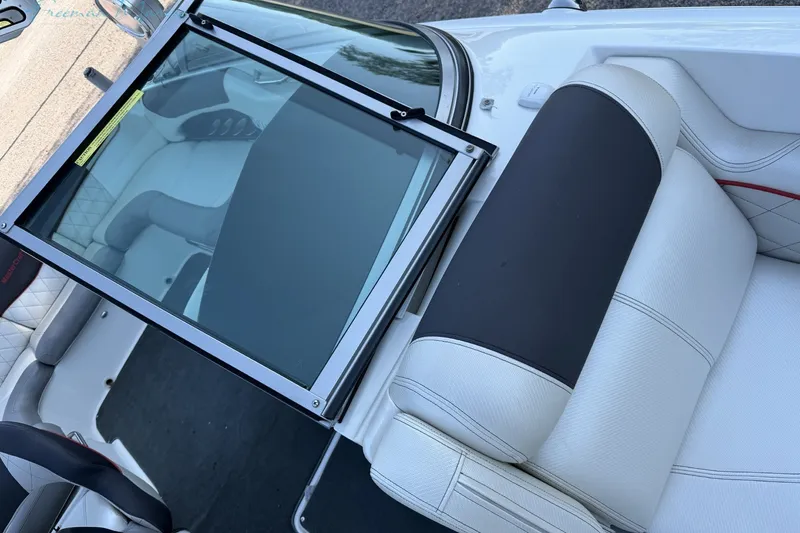 Slide: The Image of 2011 MasterCraft X-35 boat interior with white seating and windshield detail. - 28