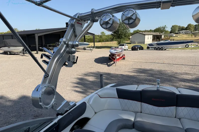 Slide: The Image of 2011 MasterCraft X-35 boat interior with speakers, parked in a marina. - 33
