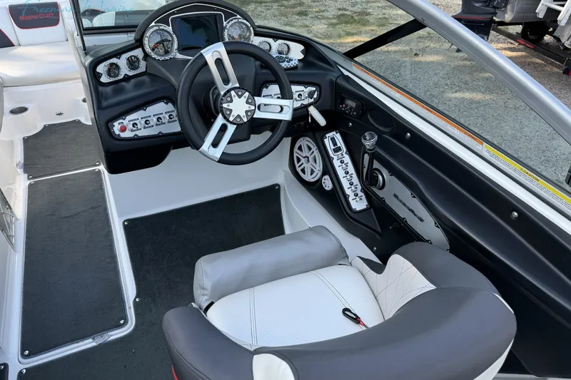 Slide: The Image of Interior of a 2011 MasterCraft X-35 boat, featuring a modern dashboard and steering wheel. - 22