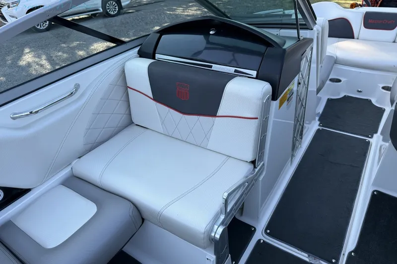 Slide: The Image of 2011 MasterCraft X-35 boat interior with white and gray seating, featuring red accents. - 36