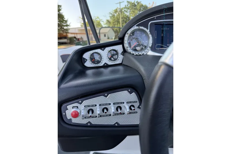 Slide: The Image of Dashboard of a 2011 MasterCraft X-35 boat with gauges and control switches. - 45