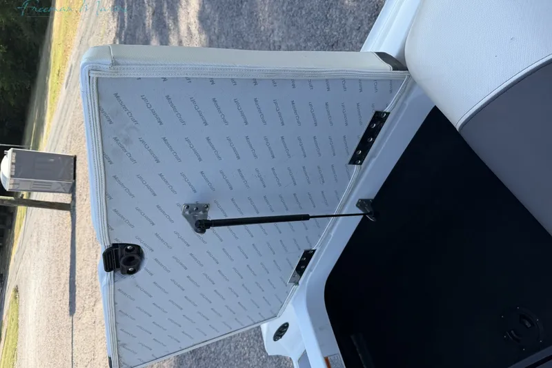 Slide: The Image of Open storage compartment of 2011 MasterCraft X-35 boat, showing interior details. - 20