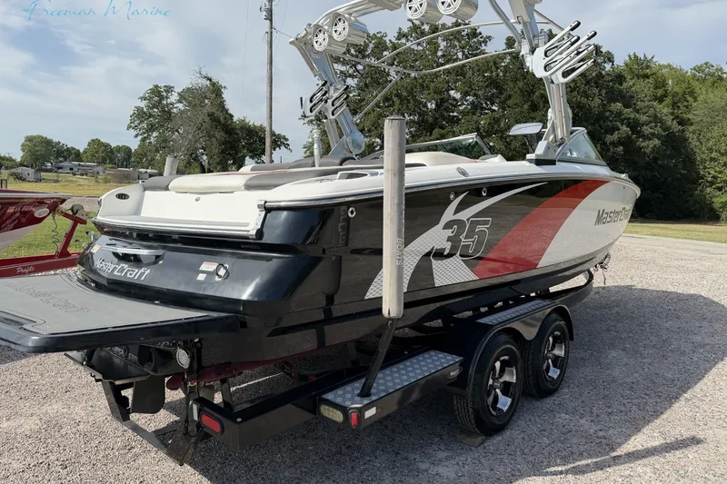 Slide: The Image of 2011 MasterCraft X-35 boat on trailer, featuring sleek design and vibrant graphics. - 3
