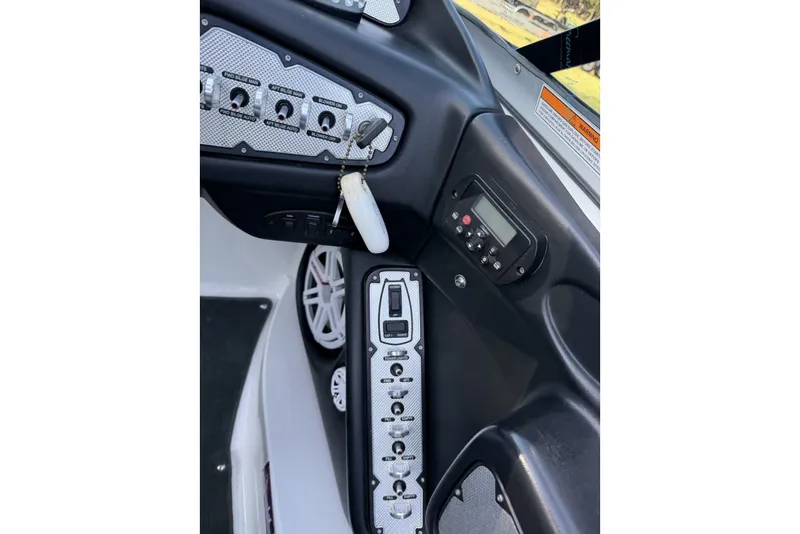 Slide: The Image of 2011 MasterCraft X-35 boat dashboard with control panel and key ignition. - 47