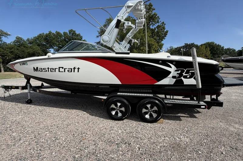 Slide: The Image of 2011 MasterCraft X-35 boat on trailer, featuring sleek design and vibrant graphics. - 8