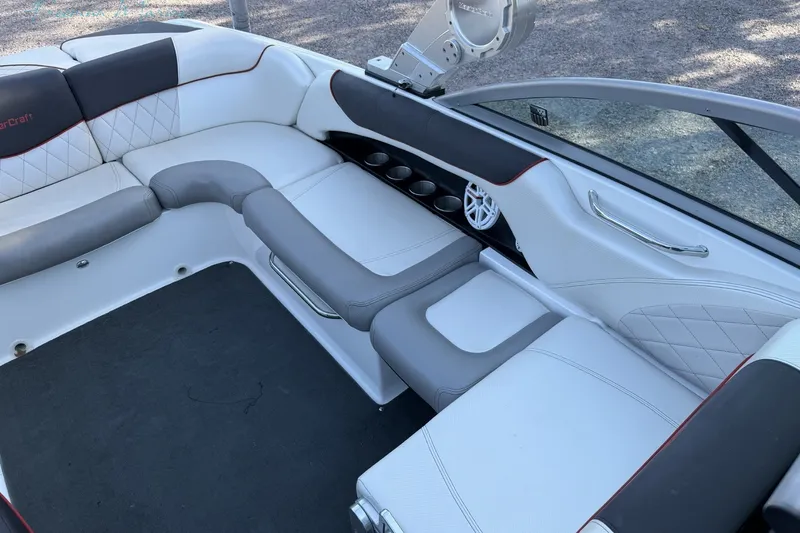 Slide: The Image of 2011 MasterCraft X-35 boat interior with white and gray seating, cup holders, and speaker. - 31