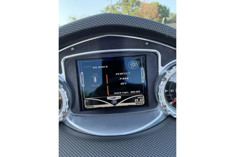 Slide: The Image of Dashboard of a 2011 MasterCraft X-35 boat with digital display and gauges. - 41