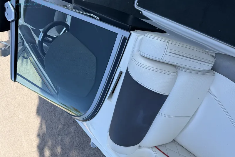 Slide: The Image of Interior view of a 2011 MasterCraft X-35 boat with white seating and steering wheel. - 29