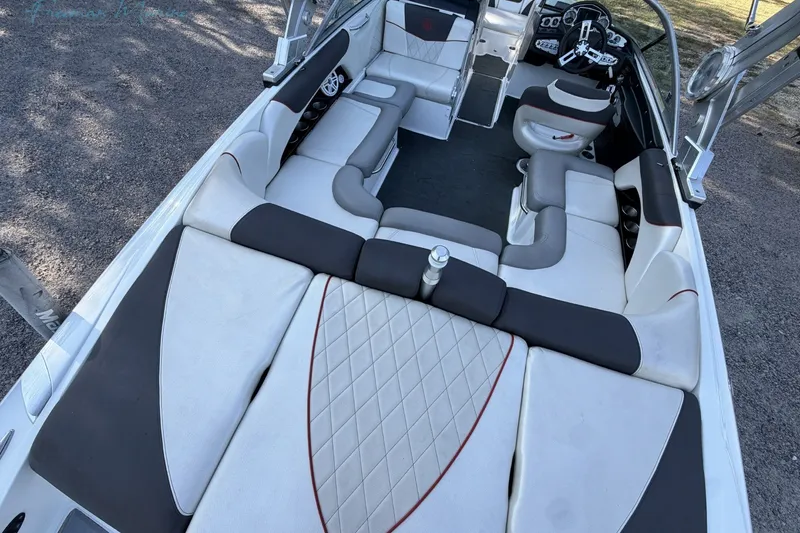 Slide: The Image of 2011 MasterCraft X-35 boat interior with spacious seating and modern dashboard. - 14